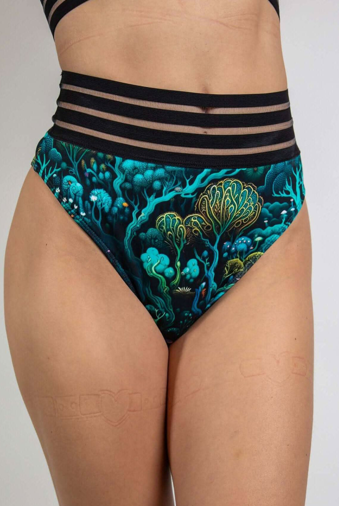Faewood Sporty Bottoms featuring a high-waisted Brazilian cut with vibrant forest-inspired prints, ideal for rave outfits.