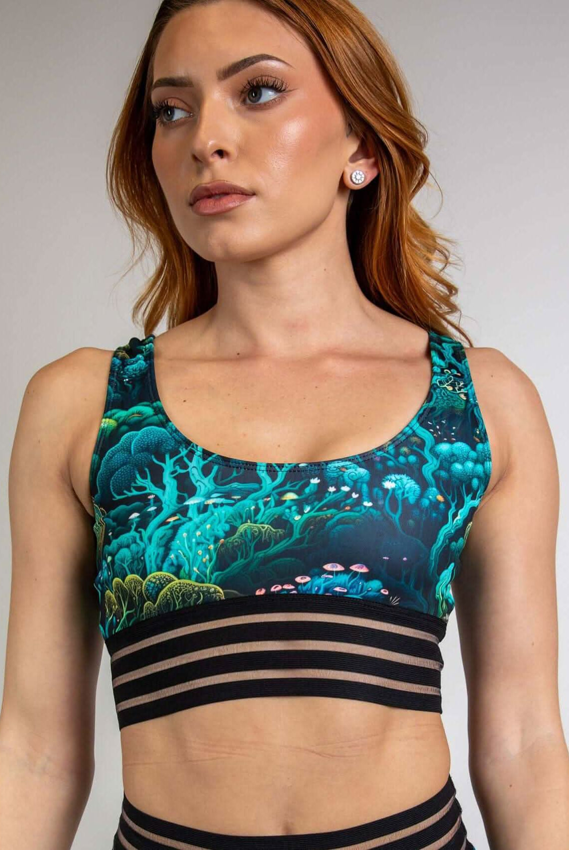 Woman wearing the Faewood Sporty Top, featuring forest-themed design and supportive wide elastic band, ideal for rave outfits.