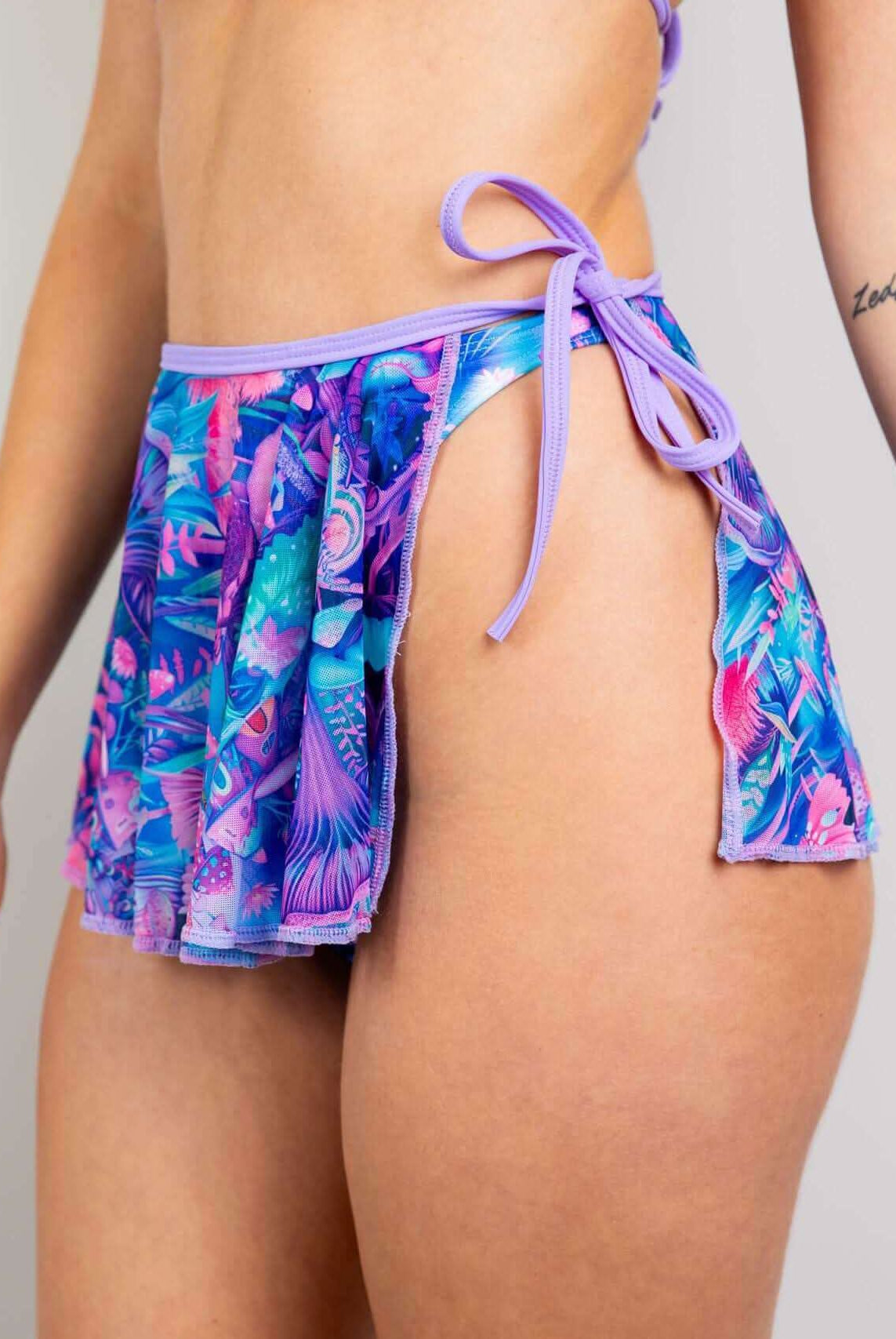 Fairycore mesh swirl skirt in vibrant colors, designed for layering with swimwear, ideal for rave outfits.