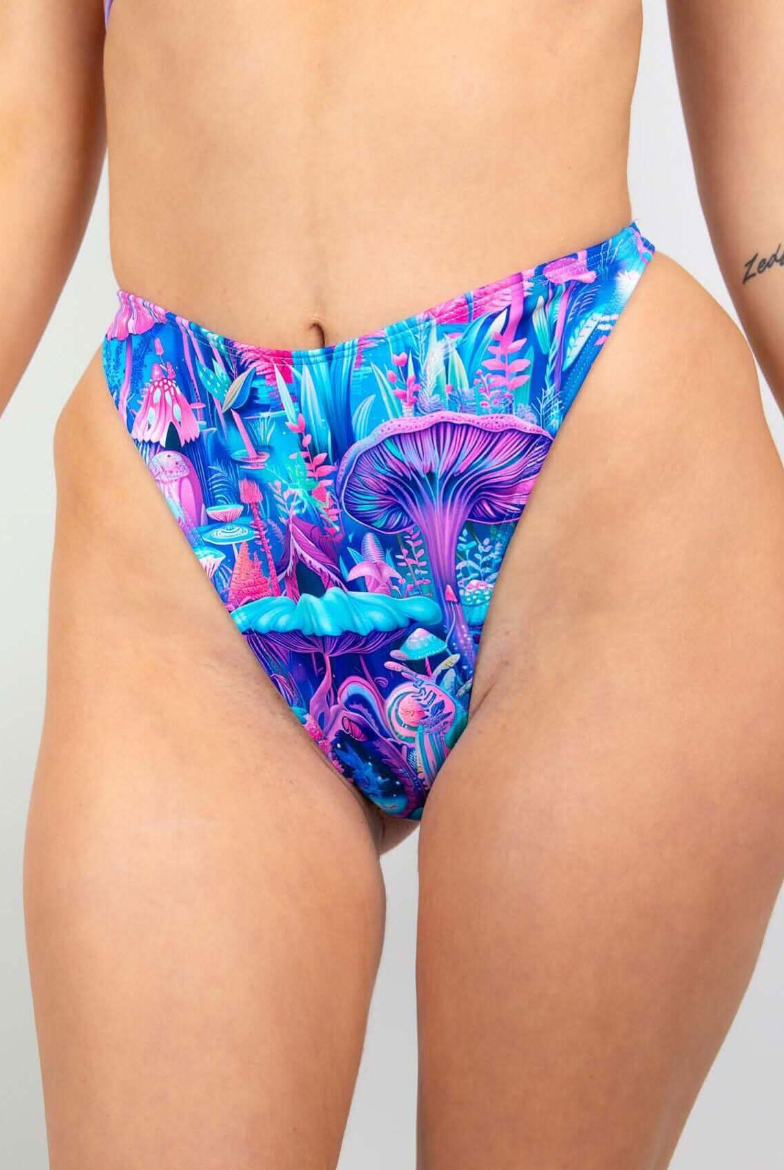 Fairycore Retro Thong Bottoms featuring a vibrant mushroom print in blue, pink, and purple, perfect for rave outfits.