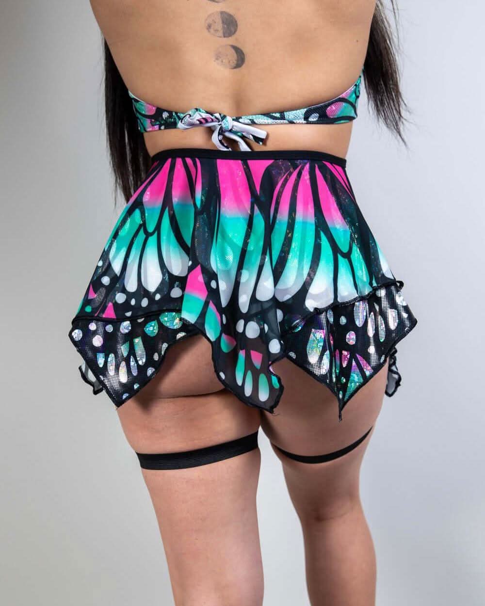 Model wearing a colorful Flutter Fairy Skirt with butterfly design, perfect for rave outfits and whimsical occasions.