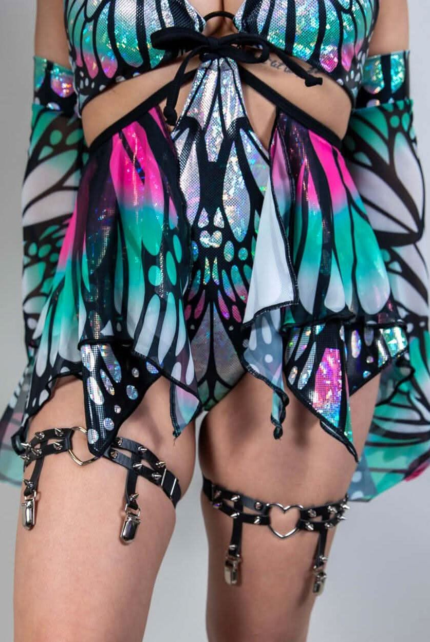 Model wearing a colorful Flutter Fairy Skirt with butterfly design, perfect for rave outfits and whimsical fashion.