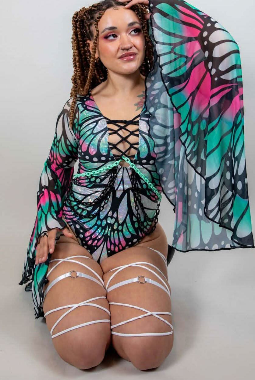 Model showcasing the Flutter Goddess Bodysuit with butterfly pattern, lace-up chest, and flowy sleeves, perfect for rave outfits.