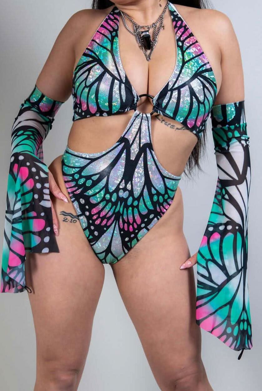 Model wearing a vibrant Flutter O-Ring Bodysuit with bold butterfly colors, perfect for rave outfits.