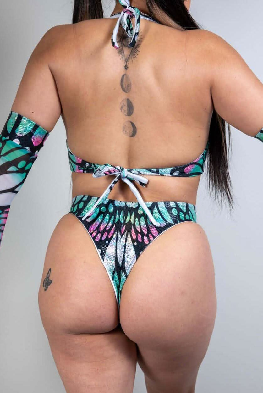 Model wearing Flutter O-Ring Bodysuit, showcasing a butterfly print, high waist thong and stylish arm sleeves.