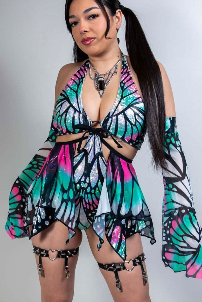 Model wearing a colorful Flutter O-Ring Bodysuit with butterfly print, perfect for rave outfits and versatile clothing.