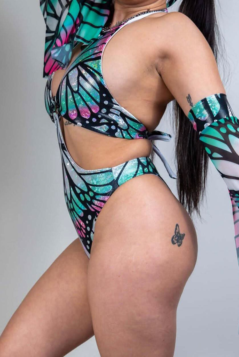 Model showcasing the Flutter O-Ring Bodysuit, vibrant butterfly design, perfect for rave outfits.