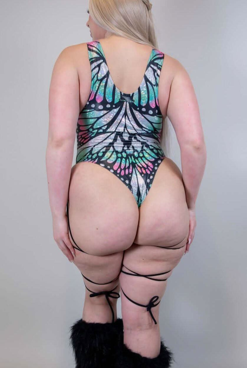Back view of a woman in a Flutter Sideboob Bodysuit with leg straps and butterfly print, ideal for rave outfits.