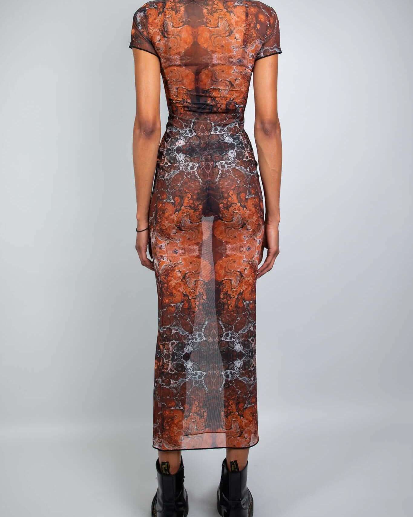 Back view of a model wearing a fitted Fossil Mesh Baby Tee Maxi Dress with cap sleeves and floor-length silhouette.