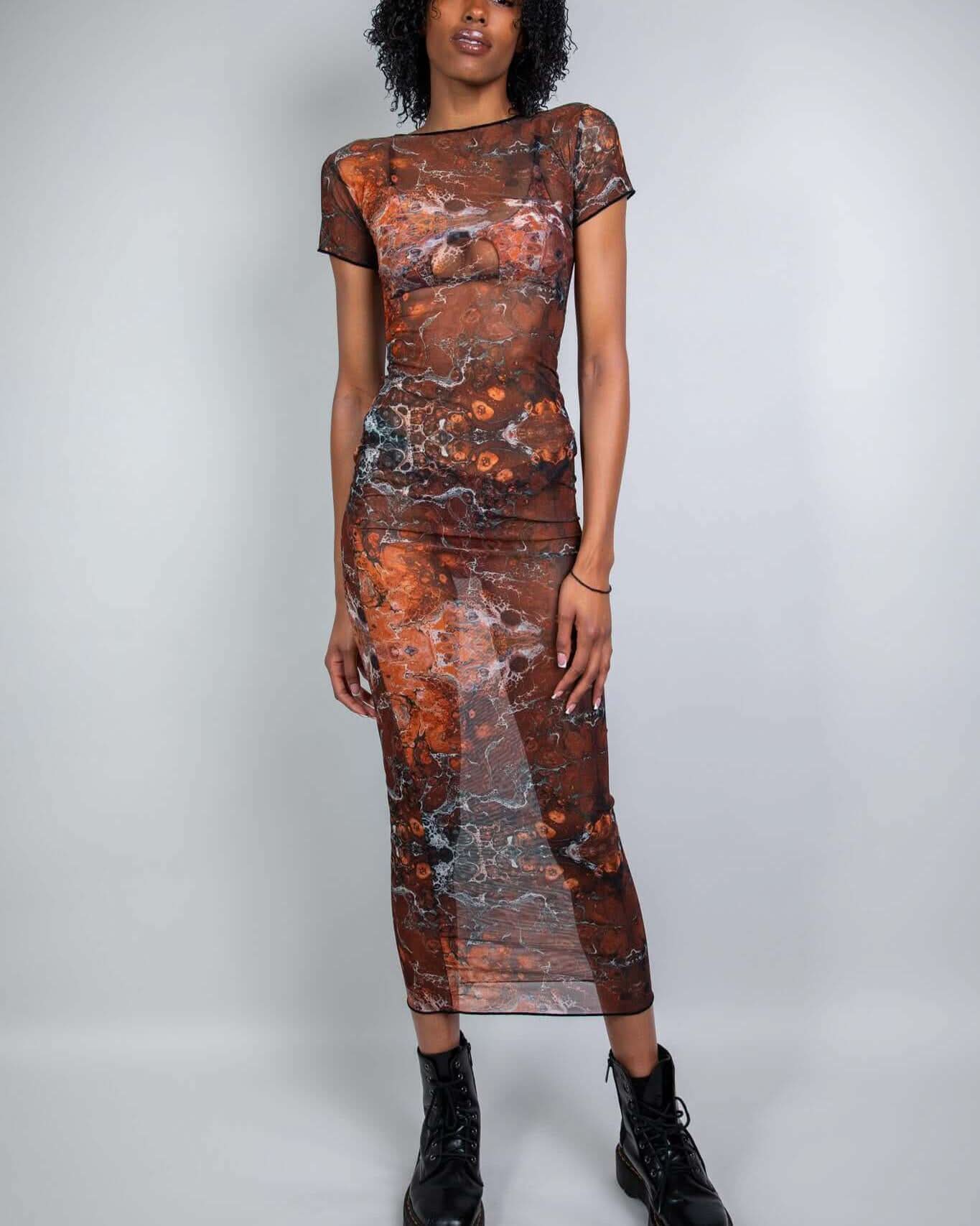 Model wearing a Fossil Mesh Baby Tee Maxi Dress, showcasing a trendy, fitted silhouette perfect for rave outfits.