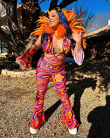 Joyful raver in vibrant orange feathered headdress and psychedelic bell-bottoms celebrates under the sunlight