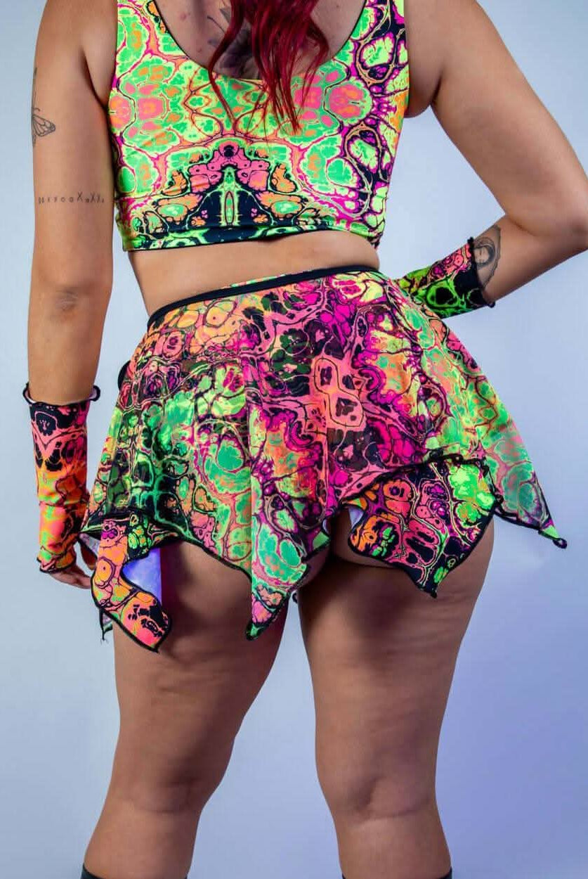 Model wearing a vibrant Intensity Fairy Skirt and matching top, perfect for rave outfits and carefree festival moments.