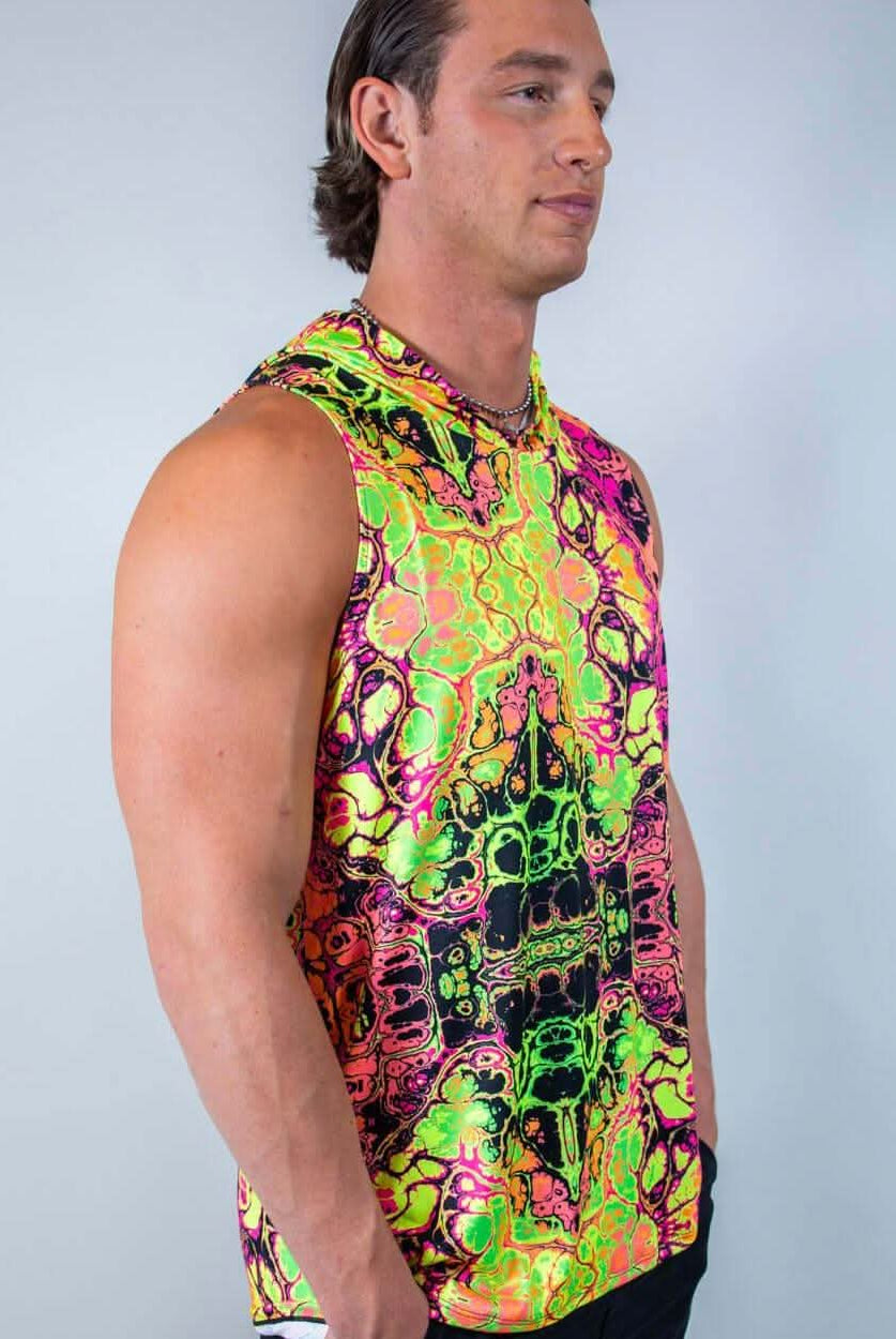 Model wearing a vibrant, neon-patterned Intensity men's tank top with hood, perfect for rave outfits.