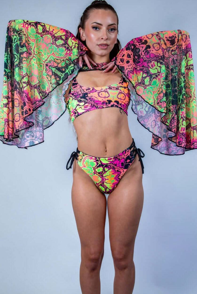Model wearing colorful Intensity Mesh Bell Sleeves with matching rave outfit, perfect for festivals and parties.