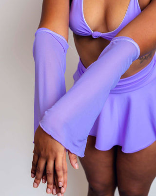 Model wearing lavender mesh flare sleeves with a matching purple outfit, showcasing a stylish rave look.