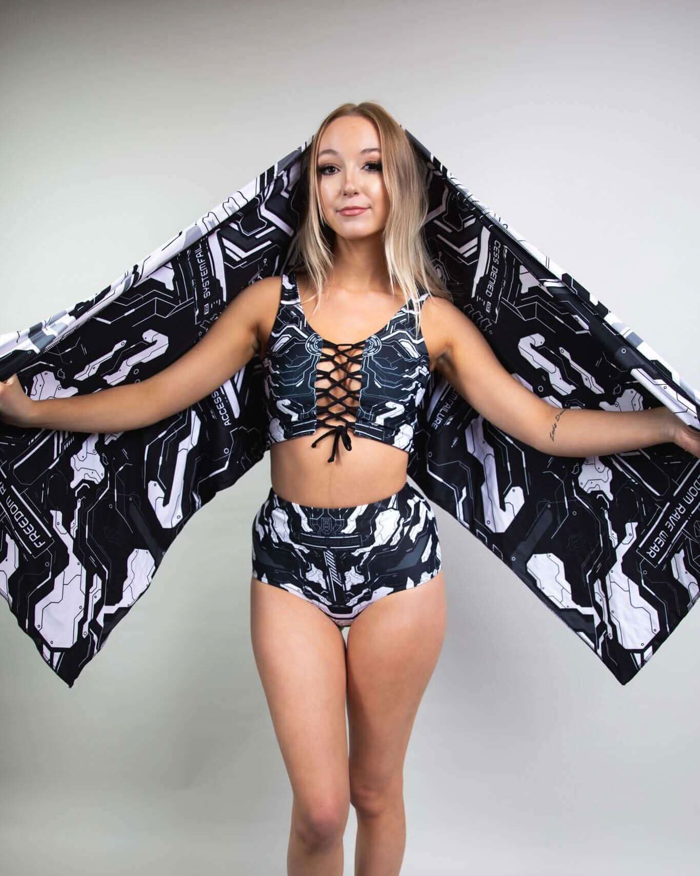 Young woman showcasing Mechanoid Reversible Festival Scarf with stylish rave outfit, featuring a modern design and comfortable fit.