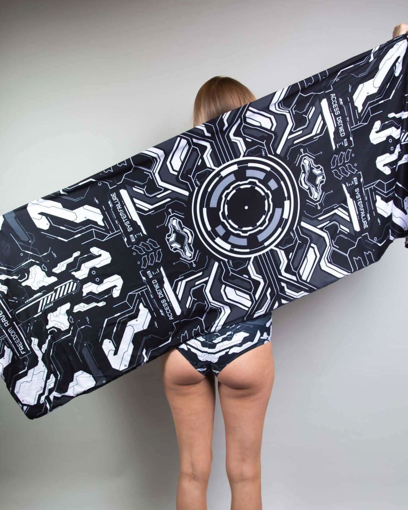 Model showcasing the Mechanoid Reversible Festival Scarf with a high-tech design, perfect for rave outfits and festivals.
