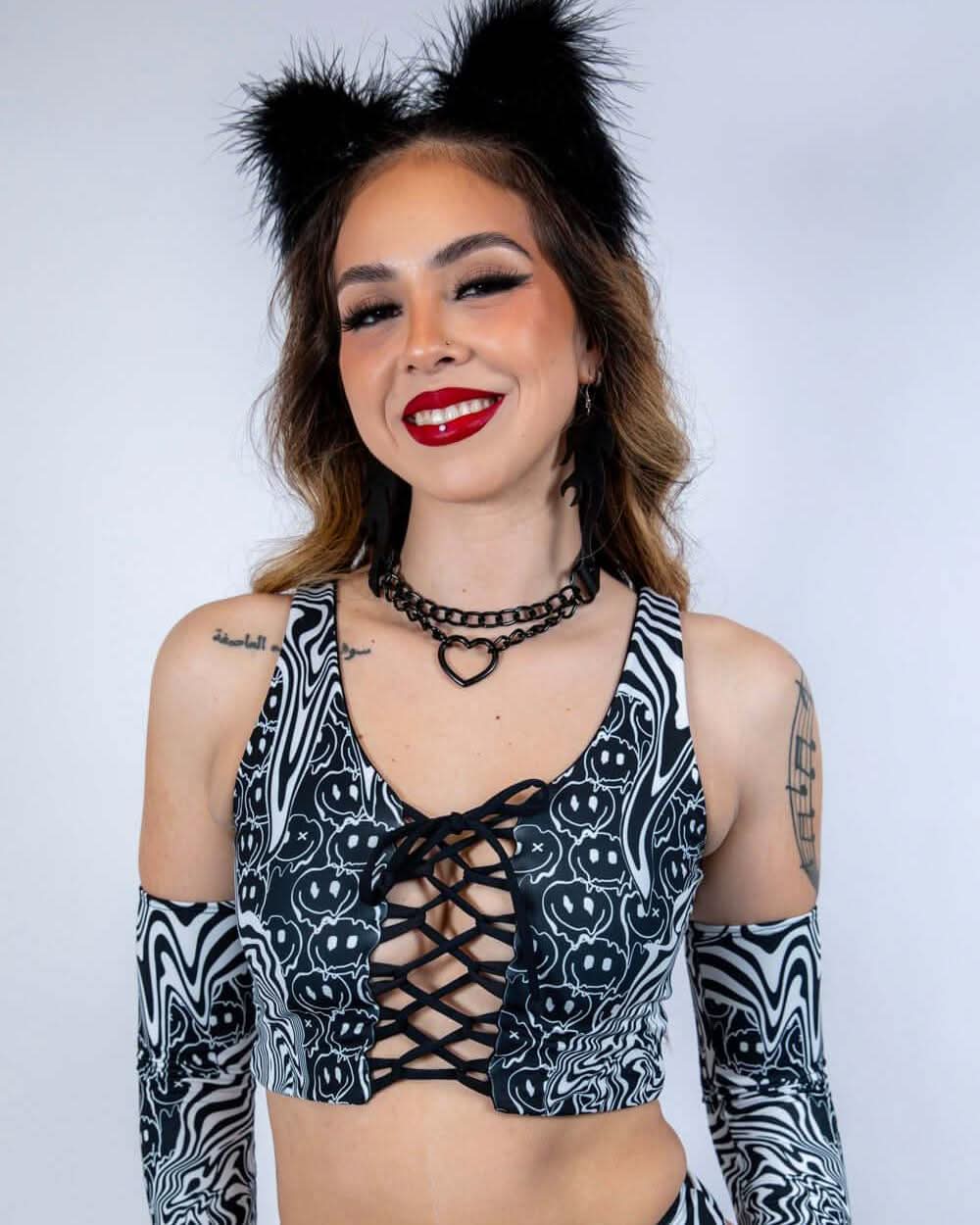 Front-facing view of the Meltdown Lace Up Top, highlighting the lace-up detail and full-length sleeves in a melty pattern.