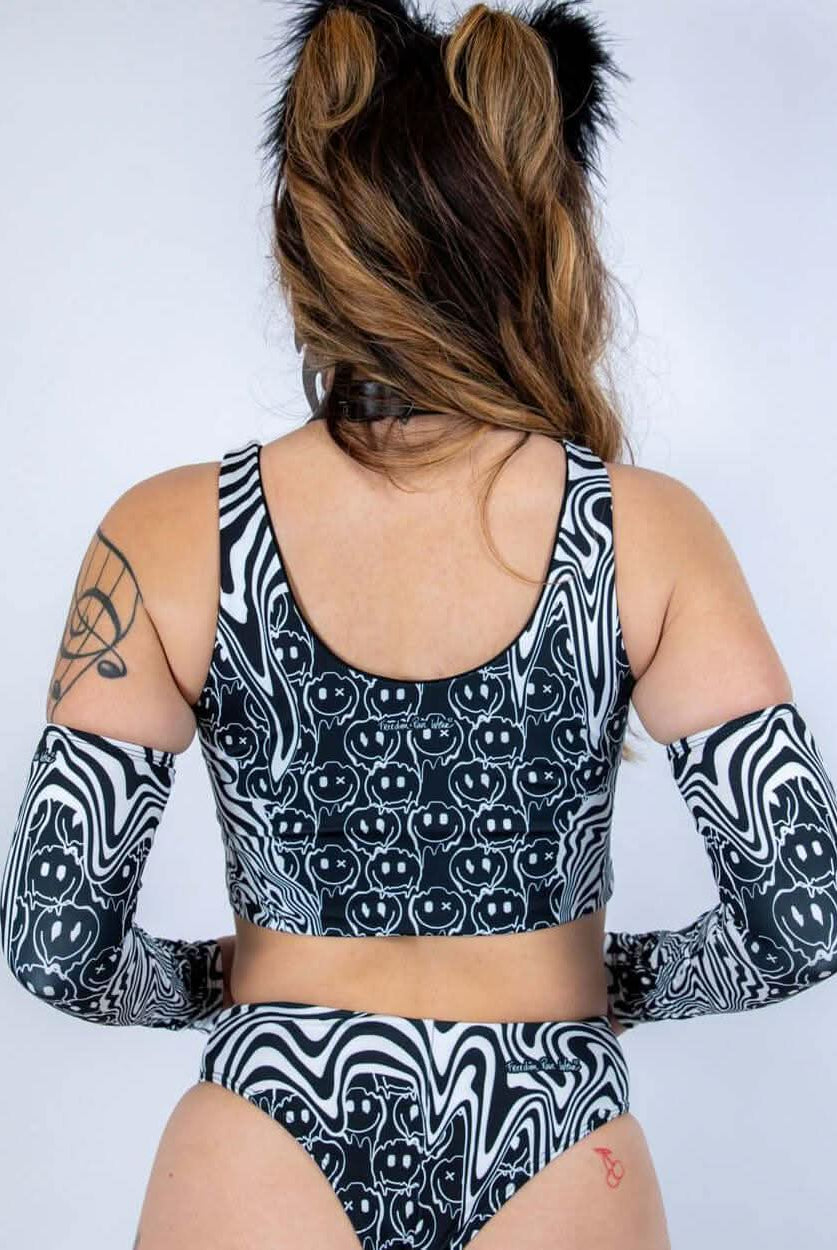 Back view of the Meltdown Lace Up Top, showcasing the scoop back cut and melty trippy print across the shoulders.