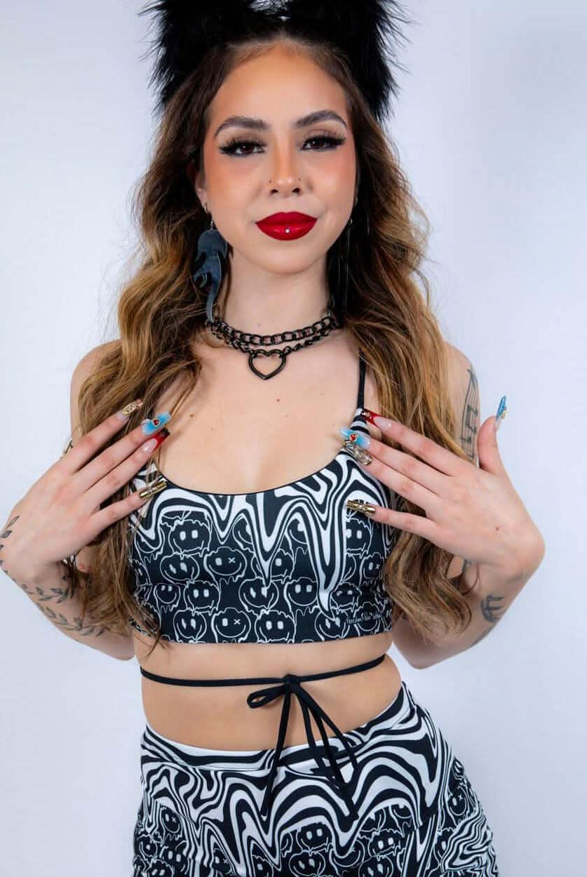 Model in the Meltdown Lush Top with arms crossed, emphasizing its sporty fit and rave-ready energy.