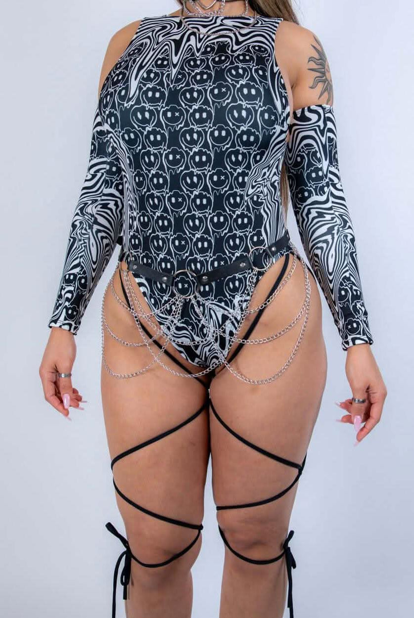 Back view of the Meltdown Sideboob Bodysuit, showing adjustable leg straps and cheeky coverage in the melty pattern.