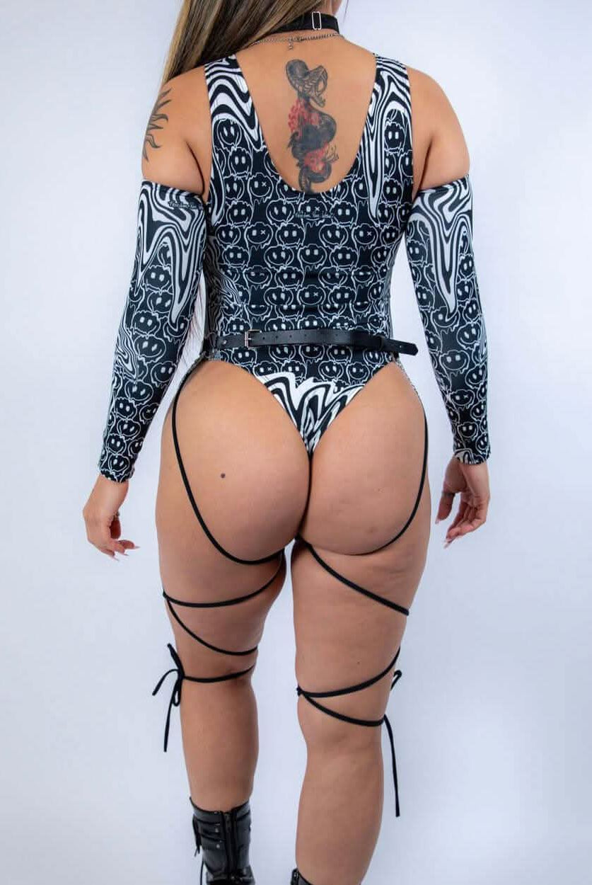 Rear view of the bodysuit with model standing tall, emphasizing strap details and full back design.
