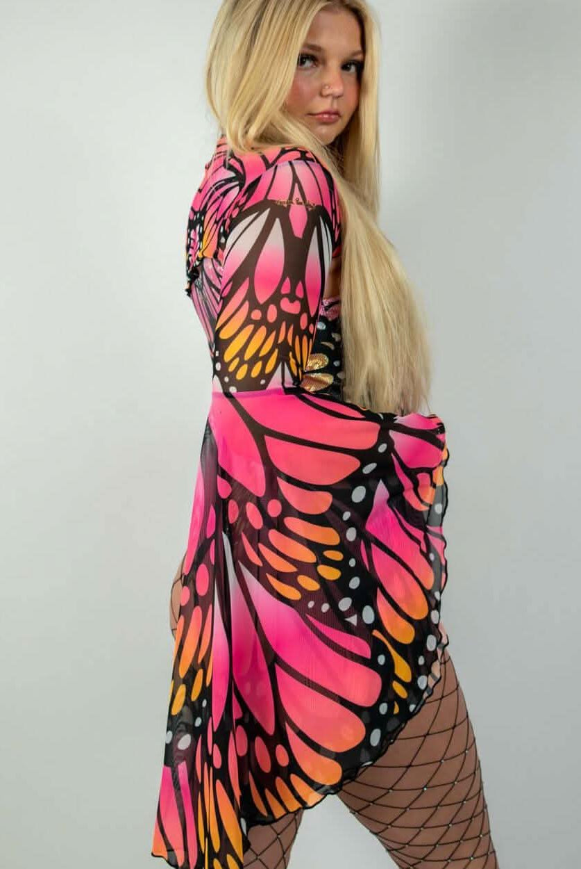 Model wearing vibrant Monarch Mesh Bell Sleeves dress, showcasing butterfly pattern, perfect for rave outfits.