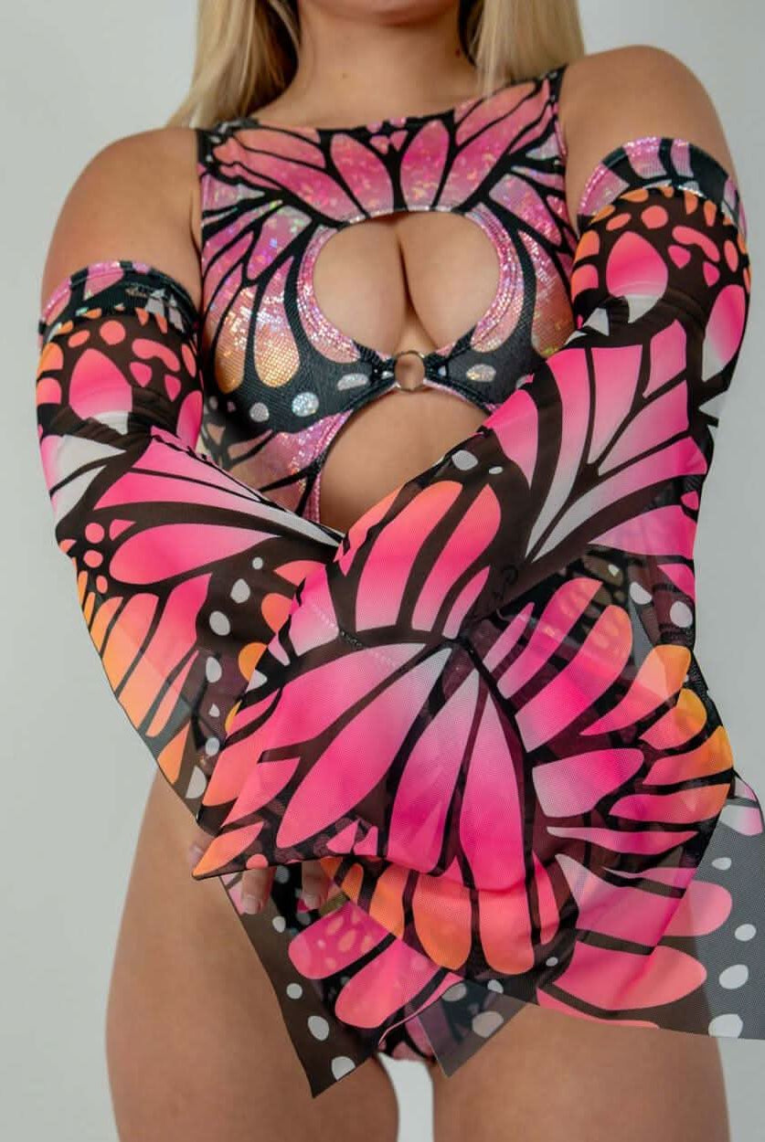 Woman modeling Monarch Metamorphosis Sleeves with butterfly design, perfect for rave outfits and clothing.