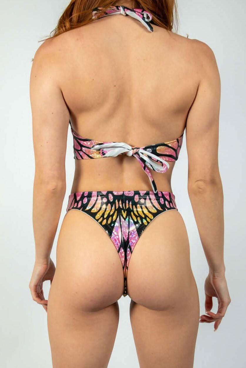 Model wearing the back view of the colorful Monarch O-Ring Bodysuit, perfect for rave outfits and versatile rave clothing.
