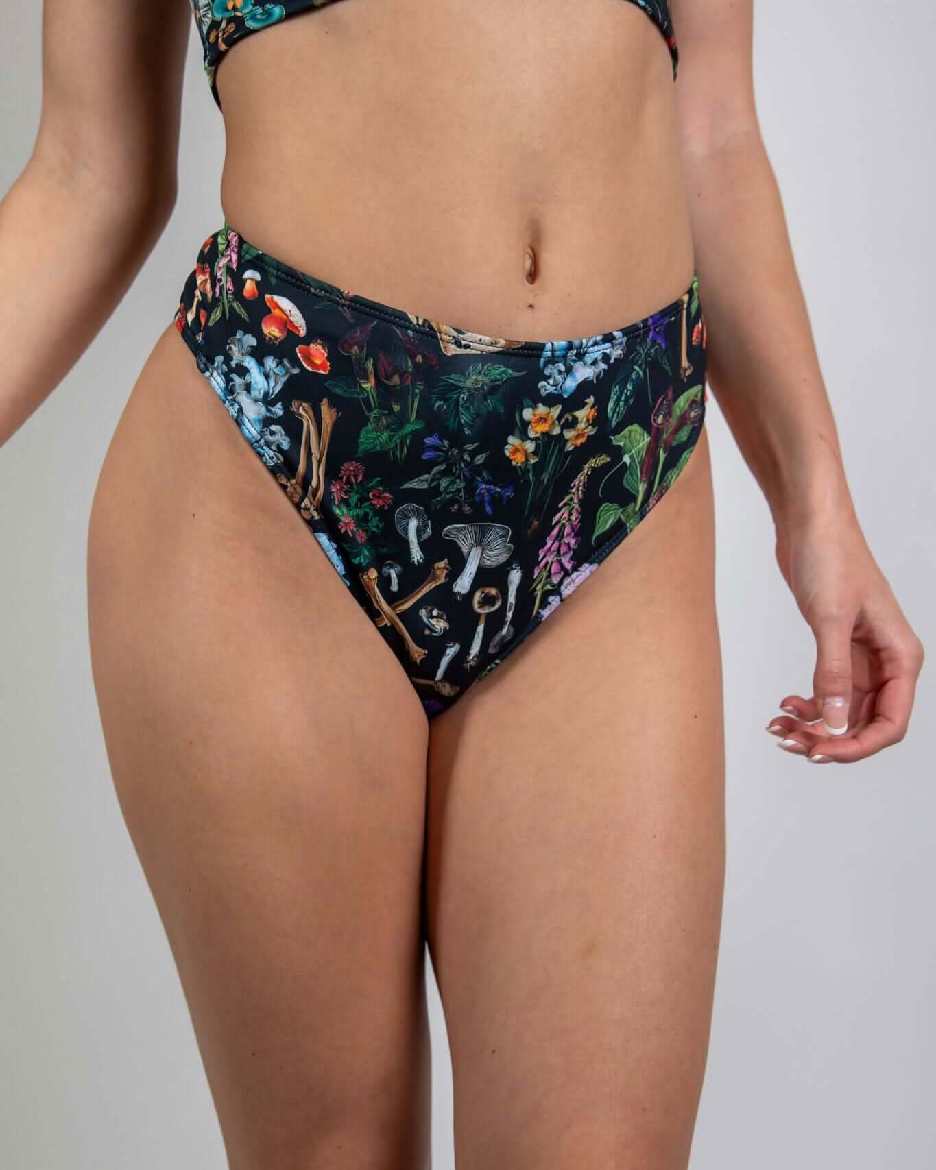 Poison High Waisted Thong featuring a bold print of skulls and mushrooms, perfect for edgy rave outfits.