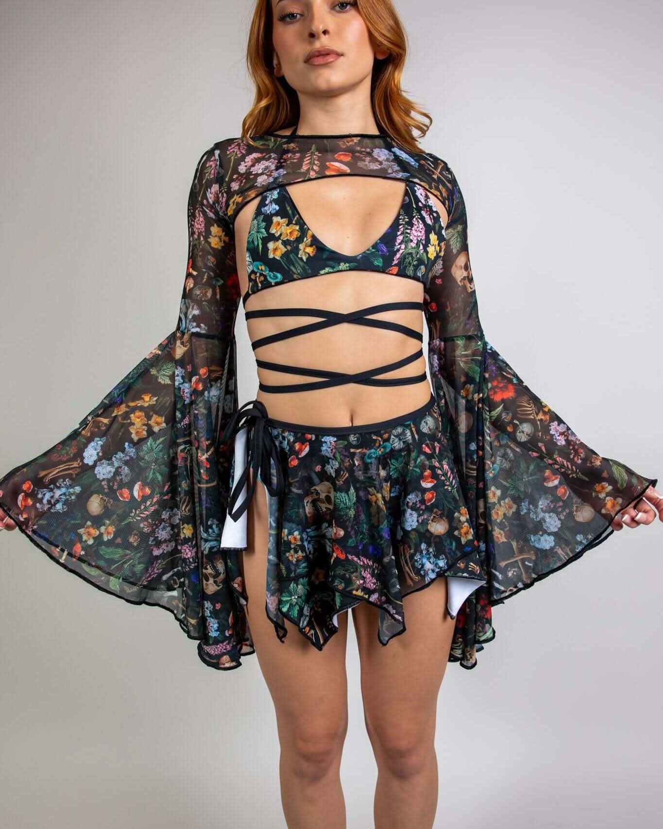 Woman modeling Poison Mesh Bell Sleeves with skulls and mushrooms print, styled for a rave outfit.