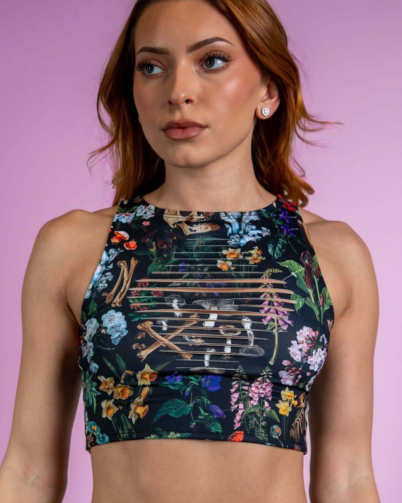 Poison Slit Crop Top with bold floral and skull print, perfect for edgy rave outfits, featuring unique slit details.