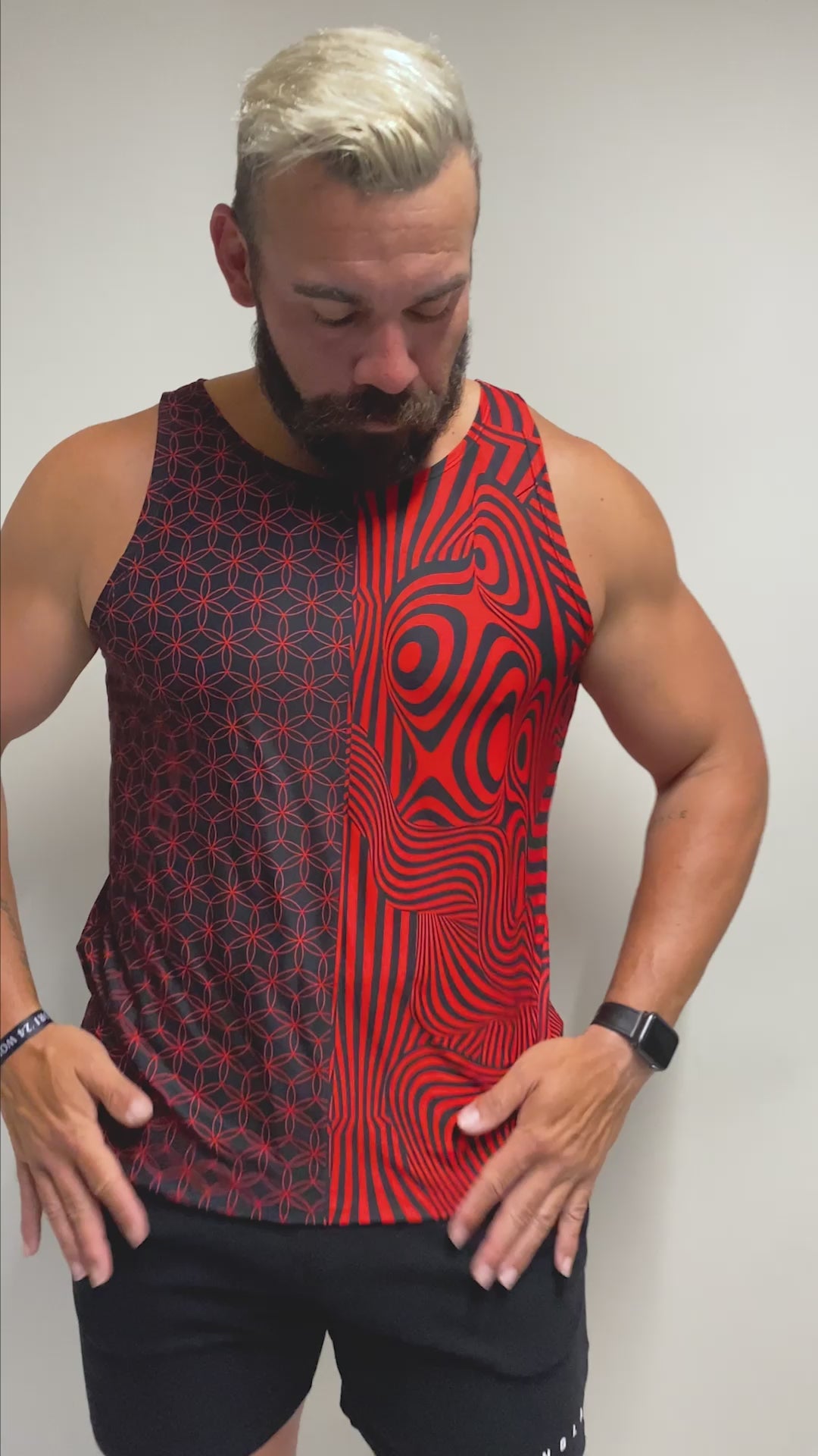 Model in a bold red and black geometric tank top from Freedom Rave Wear. Perfect for standing out at any rave with striking, hypnotic patterns. 
