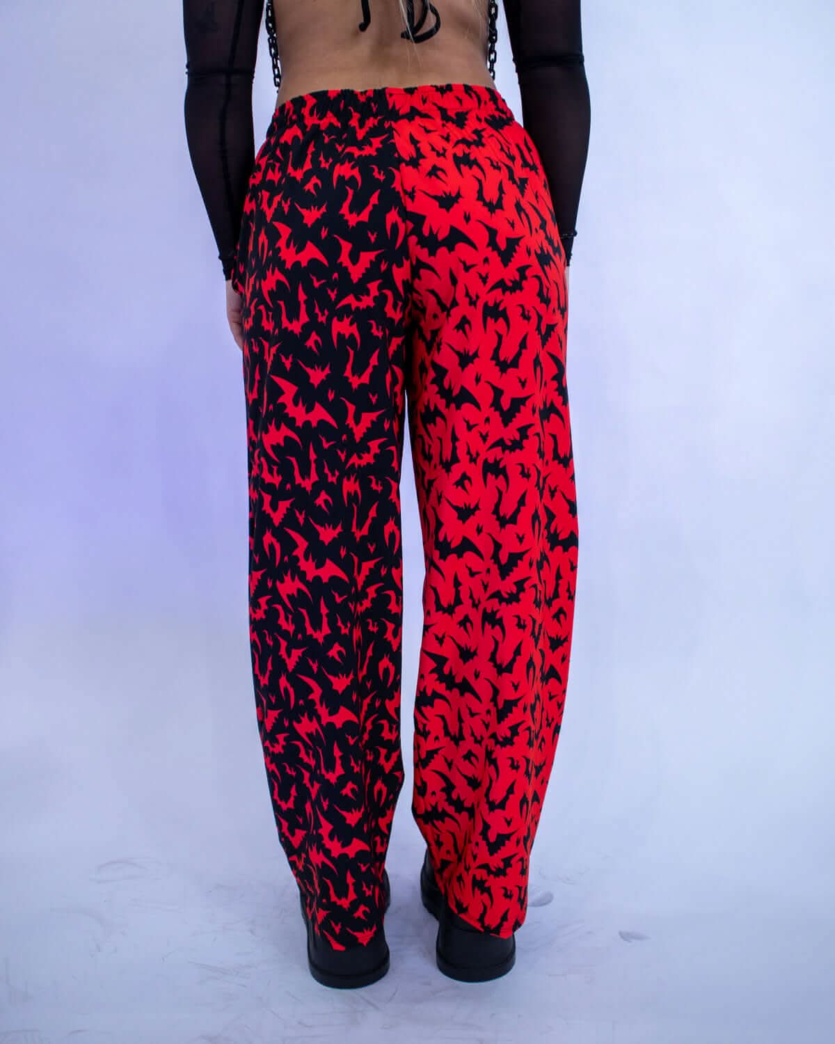 Back view of Red Batty 50/50 Lucy Pants - UV Red featuring a vibrant red and black bat pattern.
