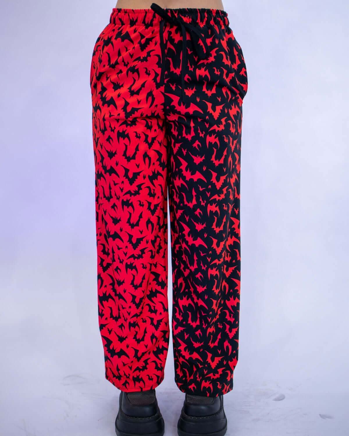 Red Batty 50/50 Lucy Pants - UV Red showcasing a red and black bat design, perfect for rave outfits.