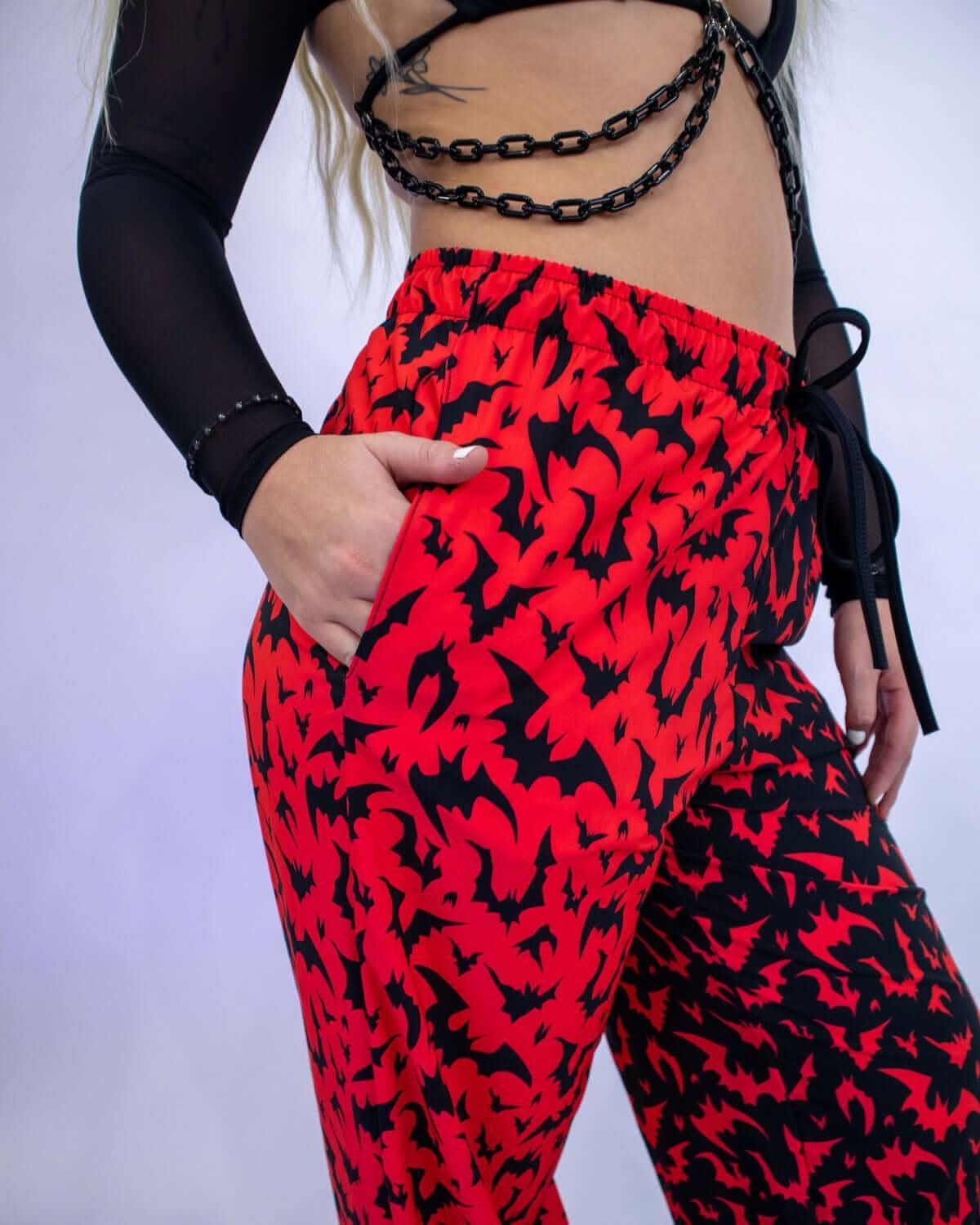 Red Batty 50/50 Lucy Pants - UV Red featuring a bold bat pattern, perfect for rave outfits and dancefloor movement.