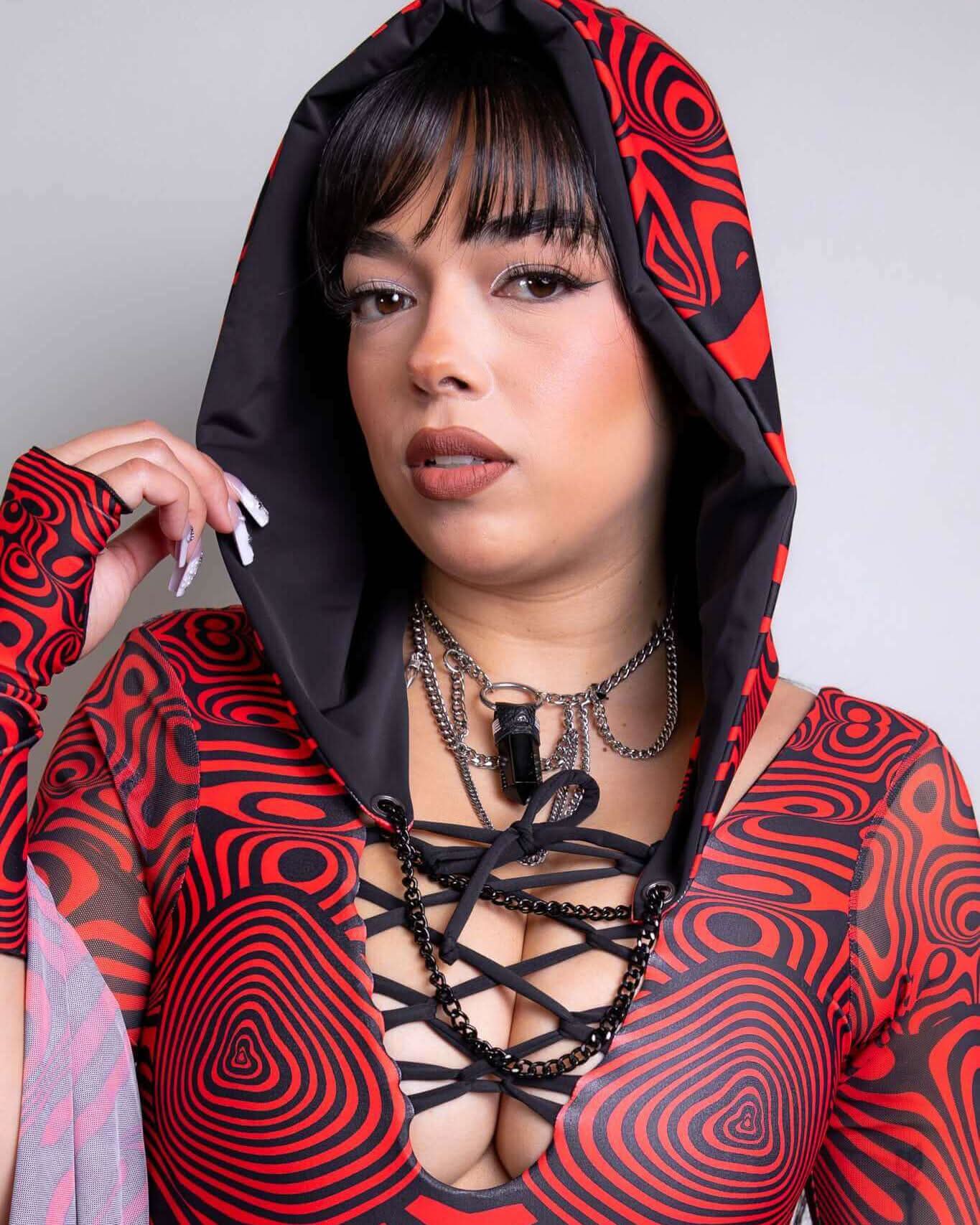 Model showcasing a Red Void Assassin Hood with bold patterns, perfect for rave outfits and cosplay.