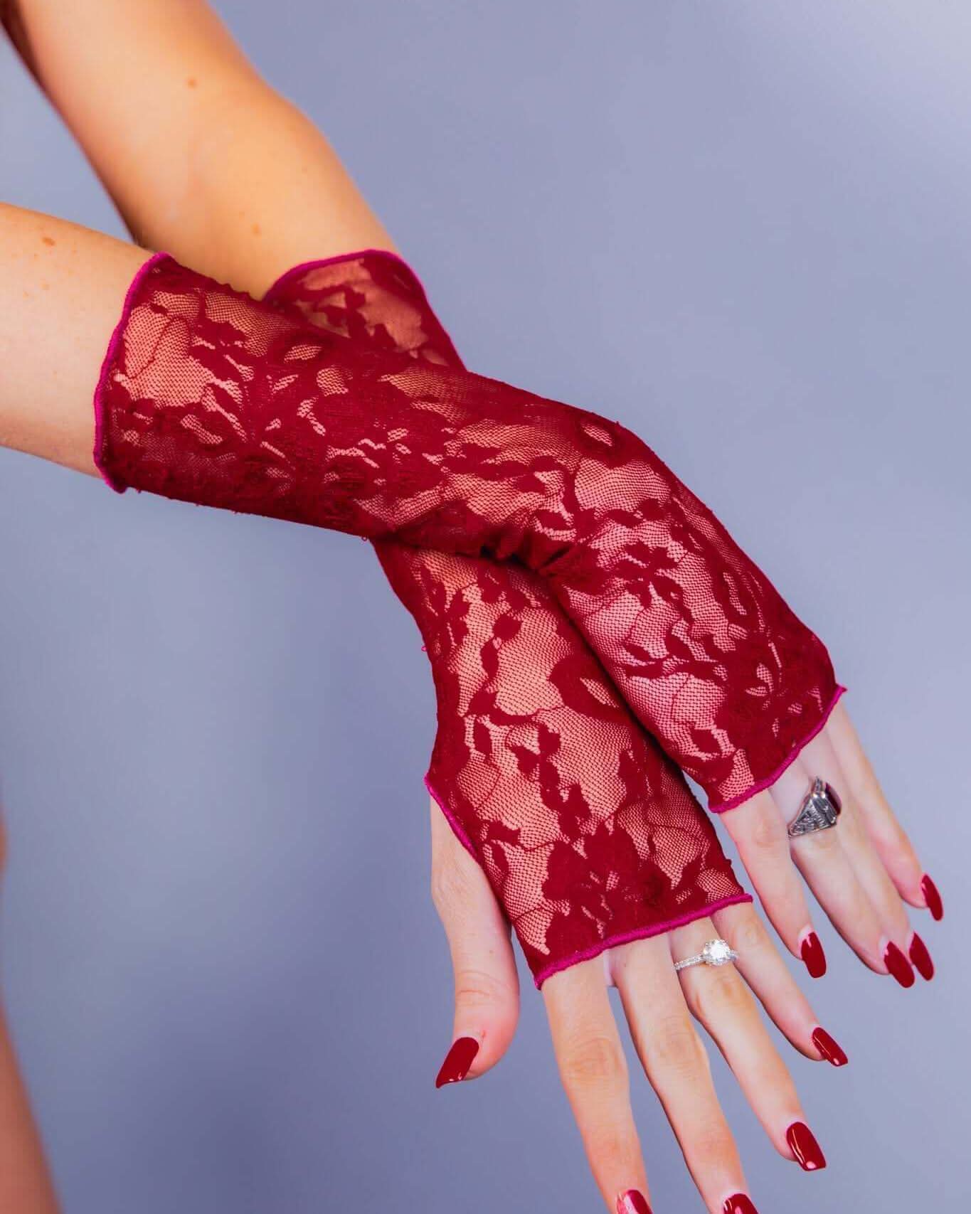 Scarlet lace gloves showcased on a model, perfect for rave outfits and featuring a stylish over-the-wrist design.