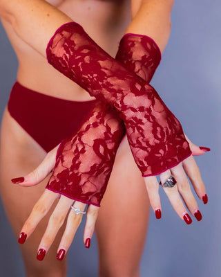 Scarlet lace gloves showcased with a model in a bikini, perfect for rave outfits and sultry fashion.