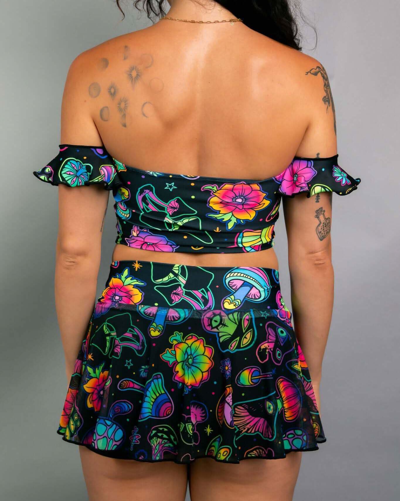 Woman wearing a colorful off-the-shoulder Bardot top and matching skirt, showcasing a playful rave outfit design.