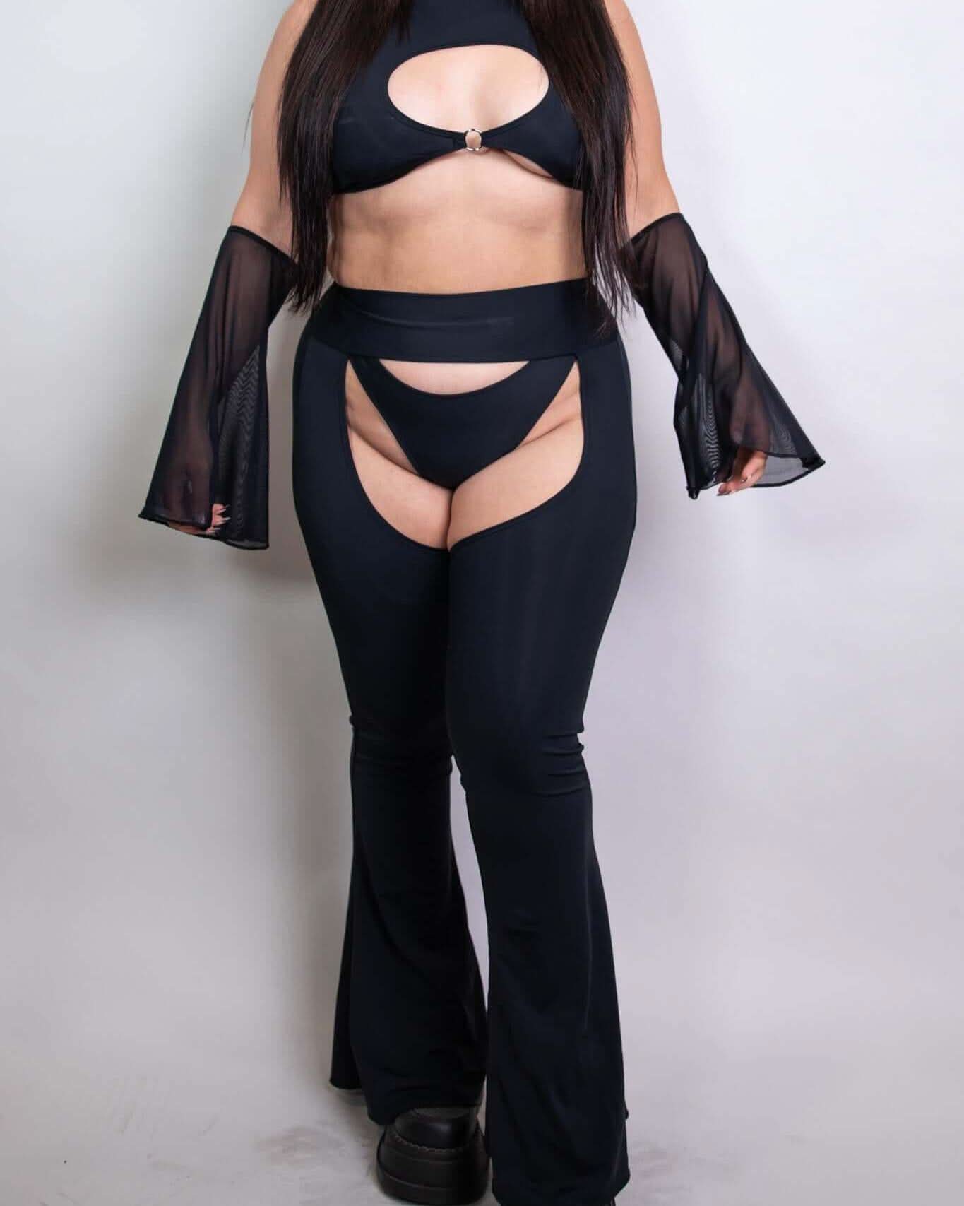 Model wearing black mesh flare sleeves with a matching crop top and cut-out pants, ideal for rave outfits and statement looks.