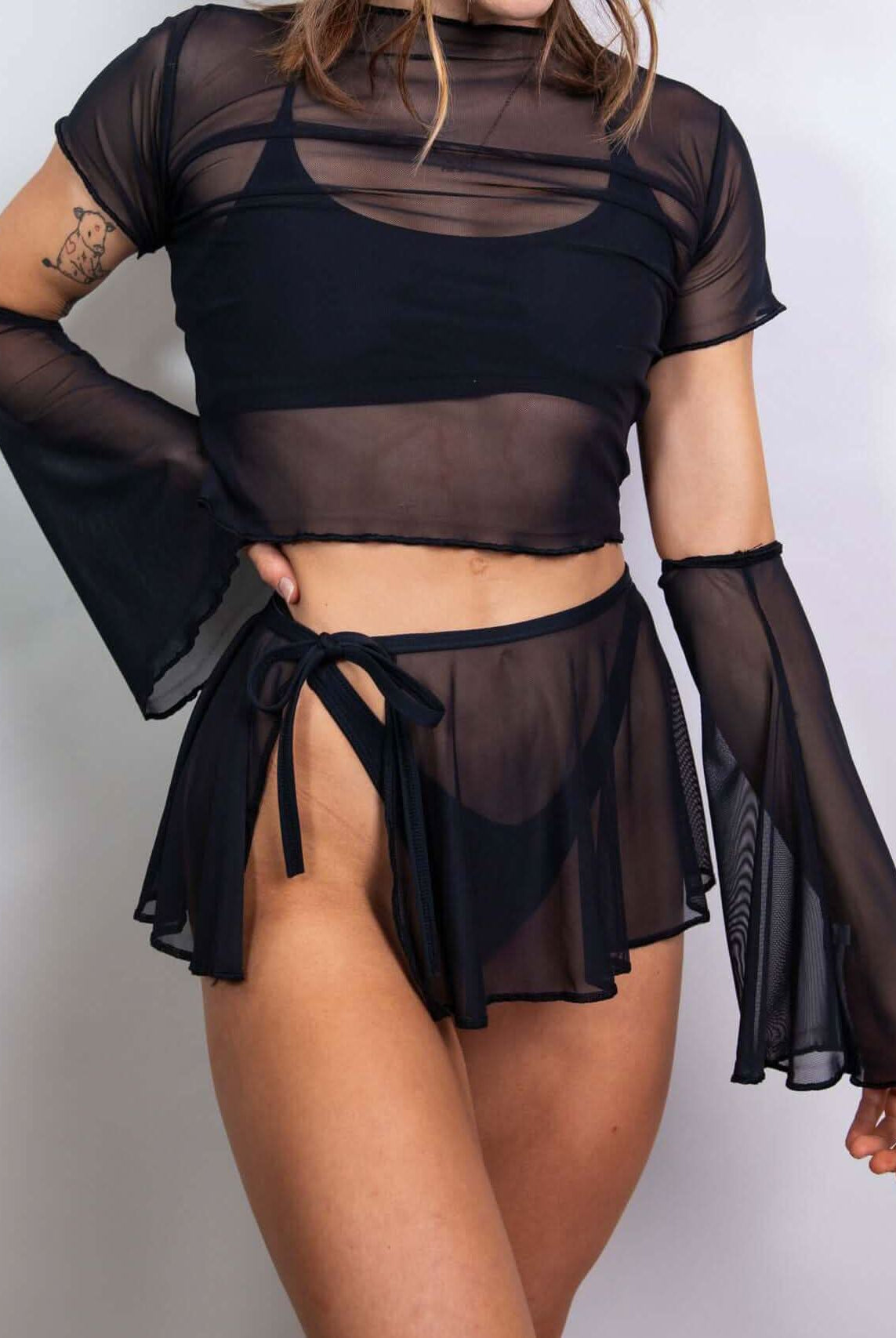 Matte black mesh flare sleeves paired with a cropped top and flowy skirt for stylish rave outfits.