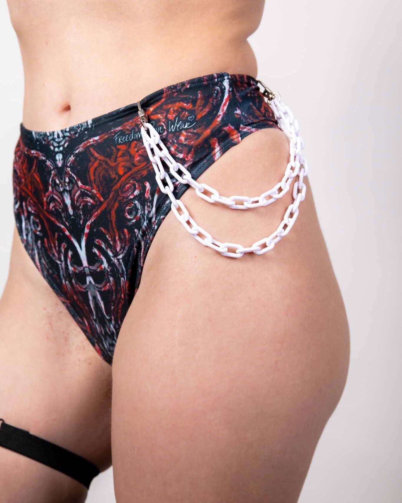 White chain belt styled with vibrant high-waisted underwear, perfect for rave outfits and festival fashion.