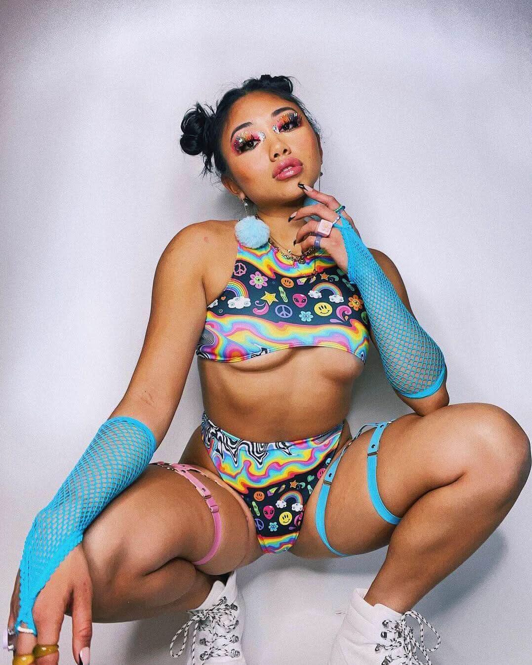 Rave outfit featuring a vibrant rainbow teaser top and colorful accessories, perfect for EDM lovers and festival vibes.