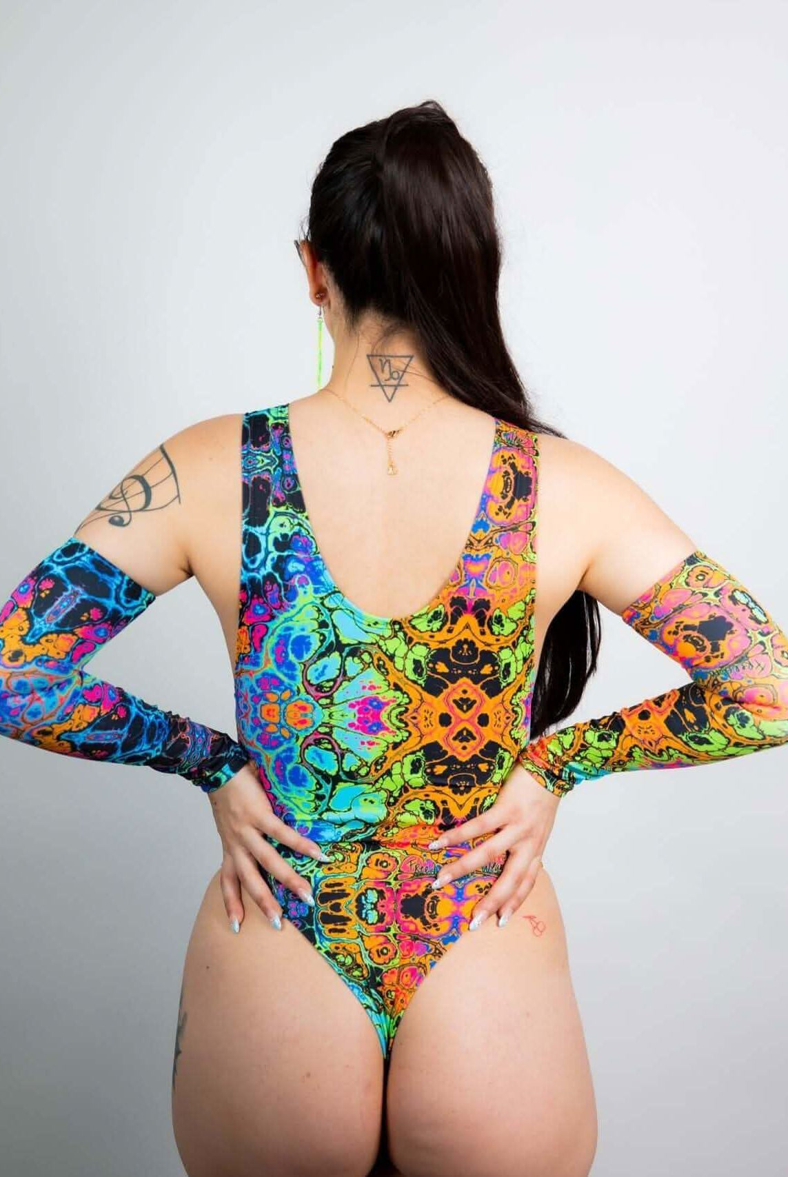 Colorful psychedelic rainbow bodysuit with high neck and long sleeves, perfect for rave outfits.