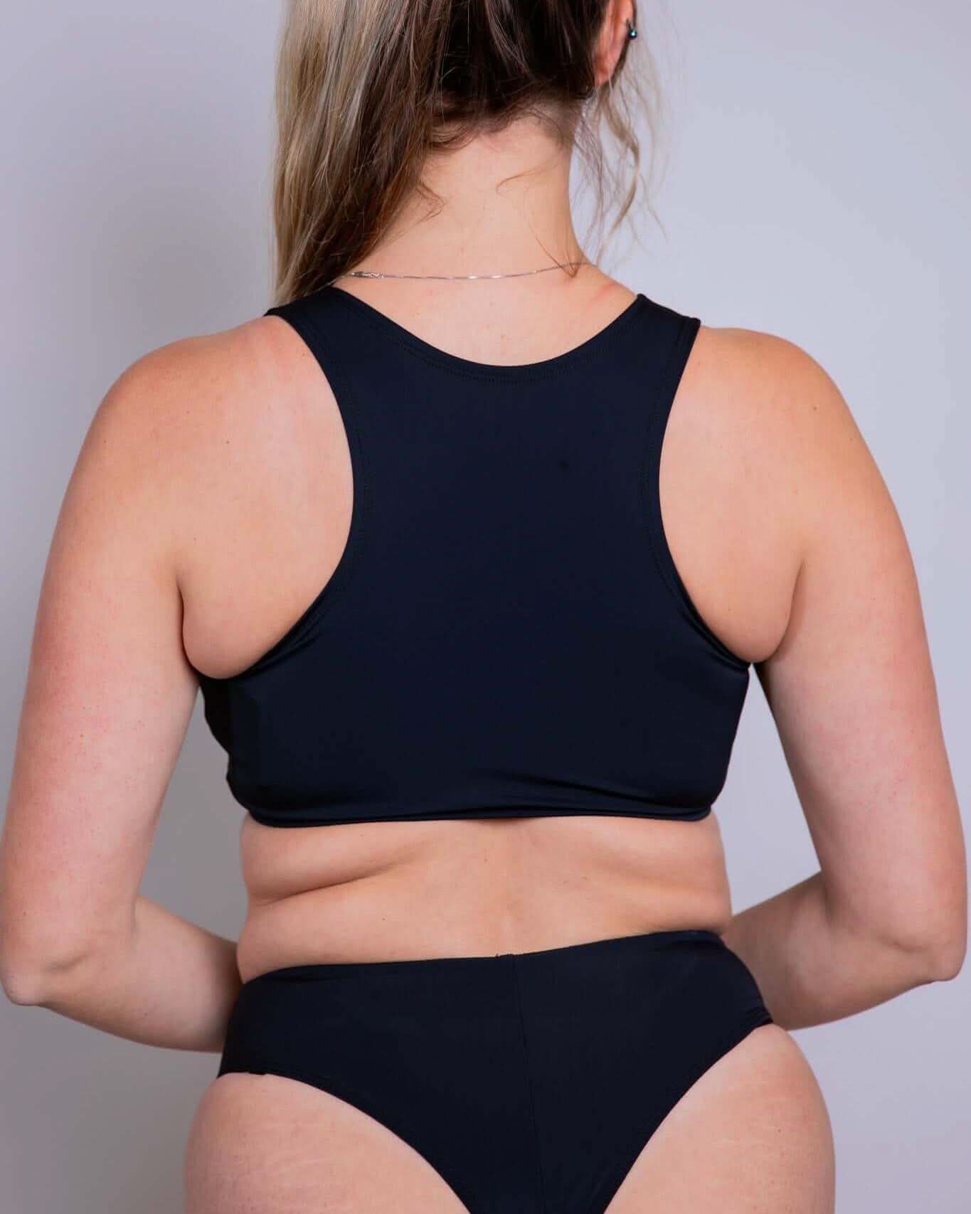 Matte black keyhole top showcasing racer back design, perfect for rave outfits and stylish night outings.