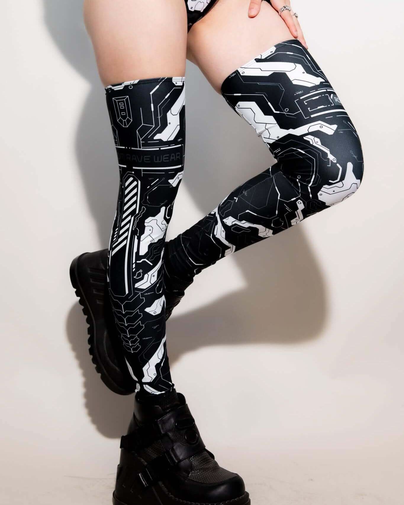 Mechanoid Leg Sleeves in black and white design, perfect for festival rave outfits, featuring eco-friendly materials.