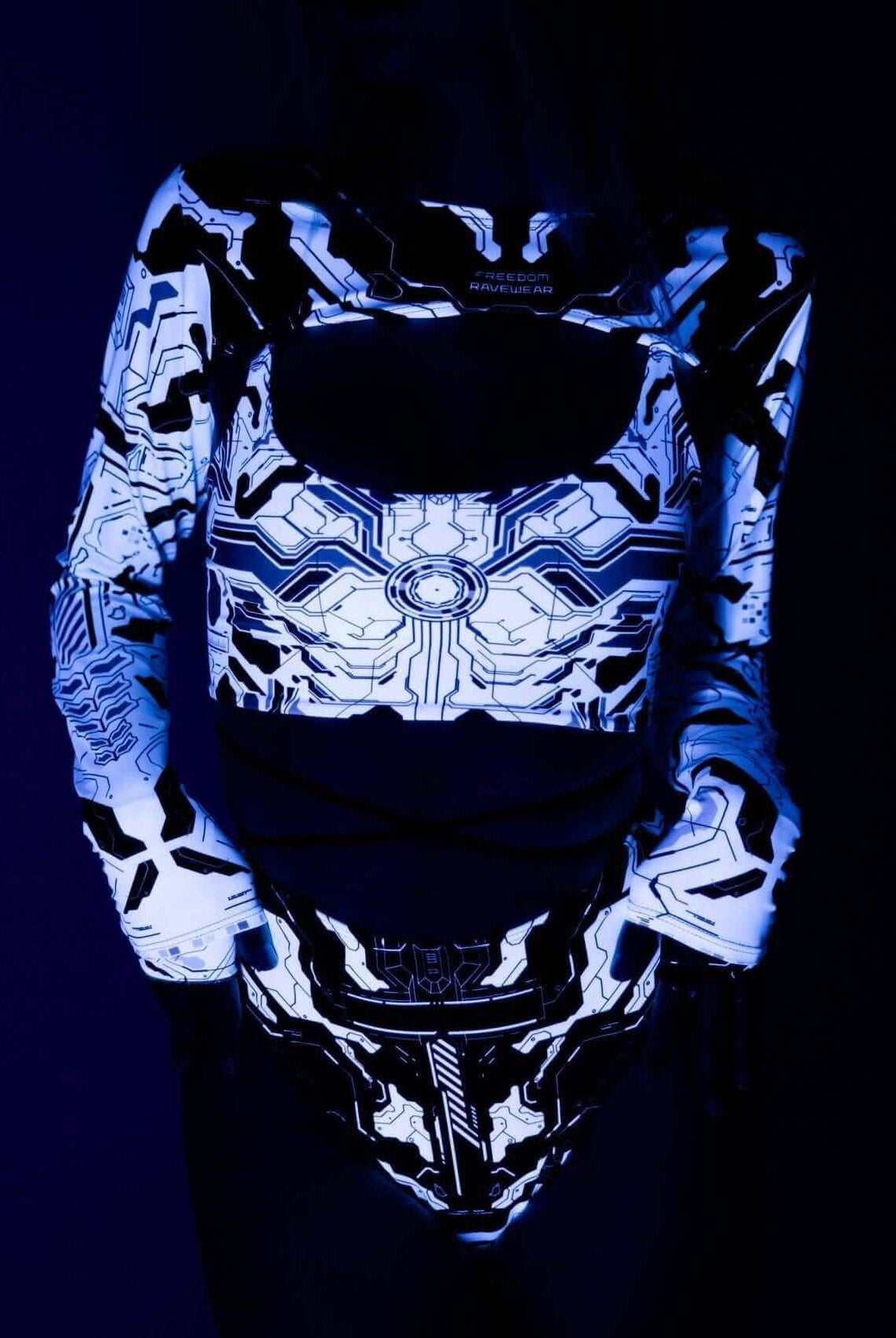 Mechanoid Reversible Lush Top featuring a vibrant circuit design, perfect for rave outfits, in a stylish blacklight setting.