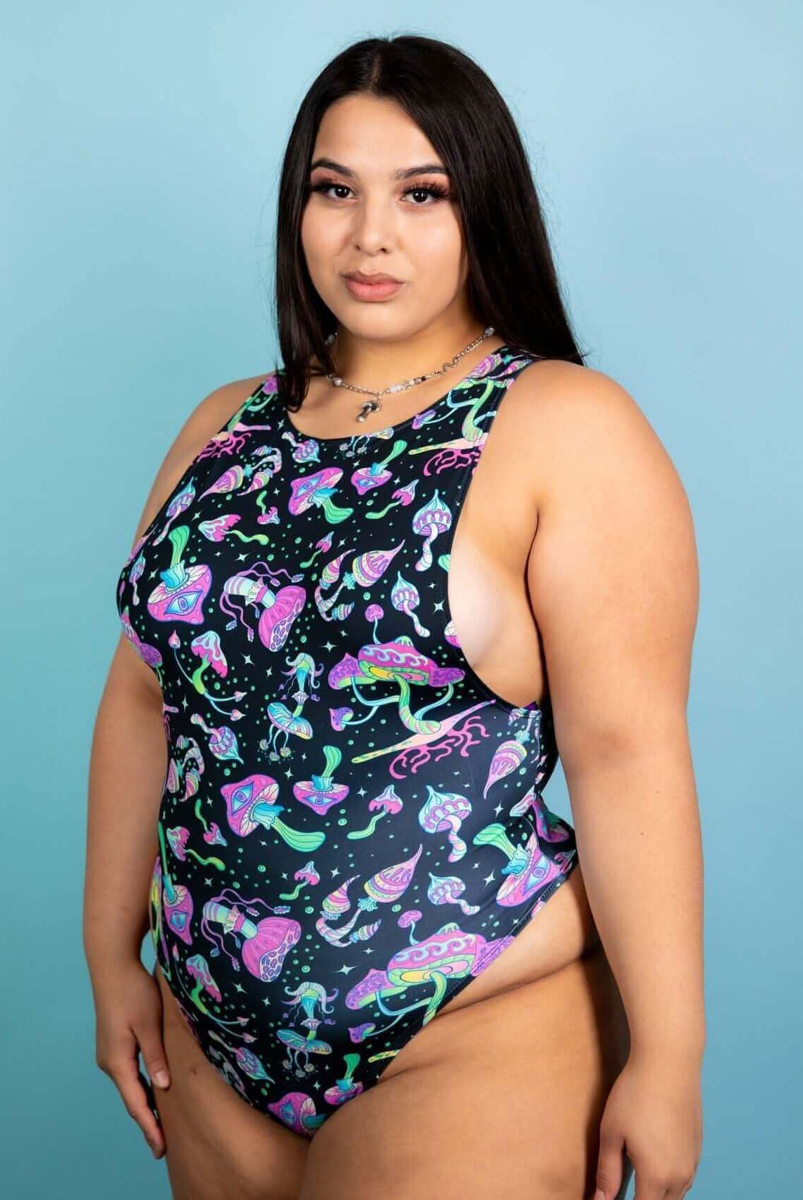 Plus size model wearing a psychedelic mushroom sideboob bodysuit, perfect for rave outfits and festivals.