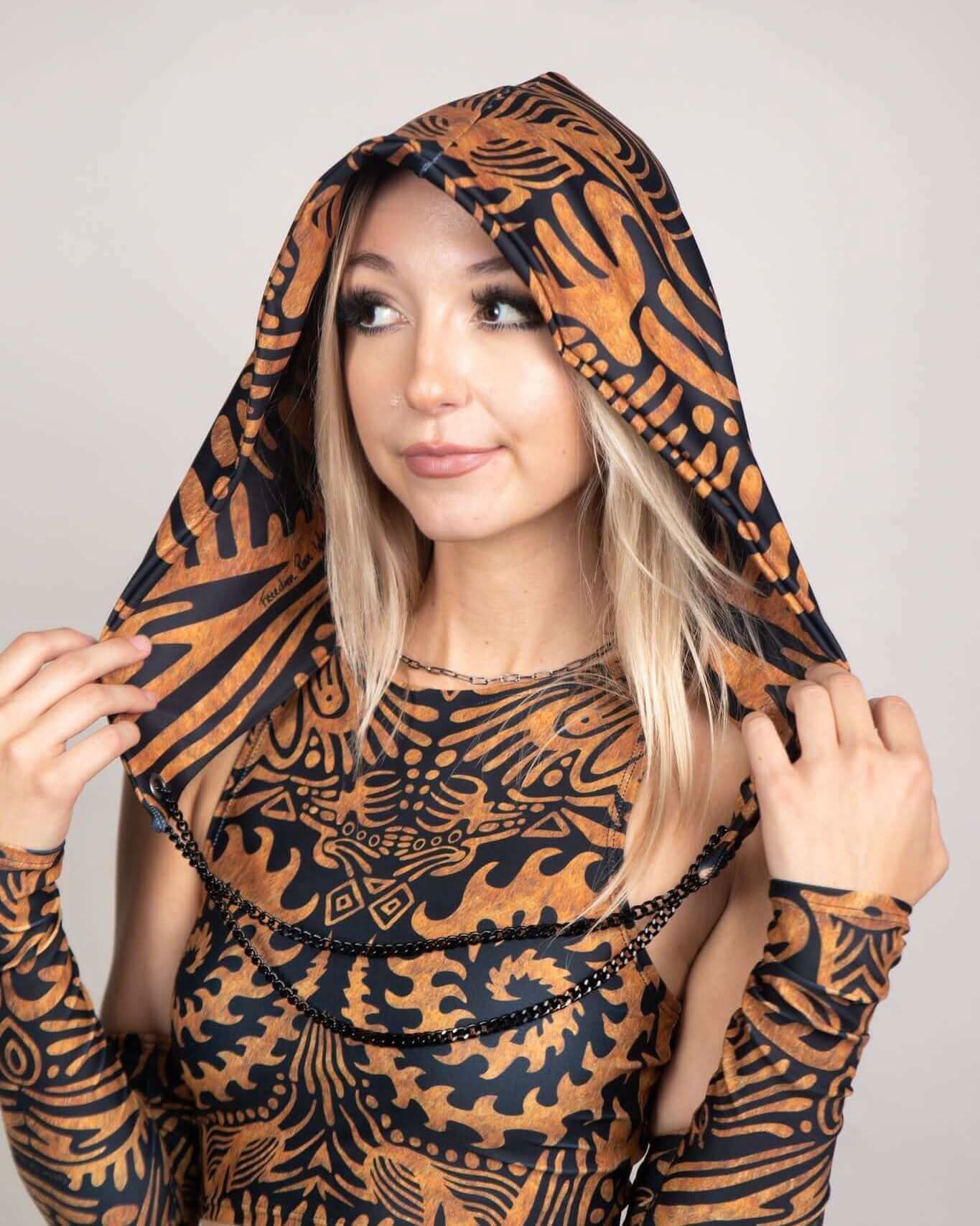 Model wearing Primal Assassin Hood, a unique festival accessory perfect for rave outfits, featuring intricate patterns.